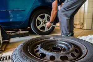A mechanic replacing a tire