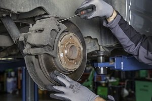 A mechanic repairing a car disc brake