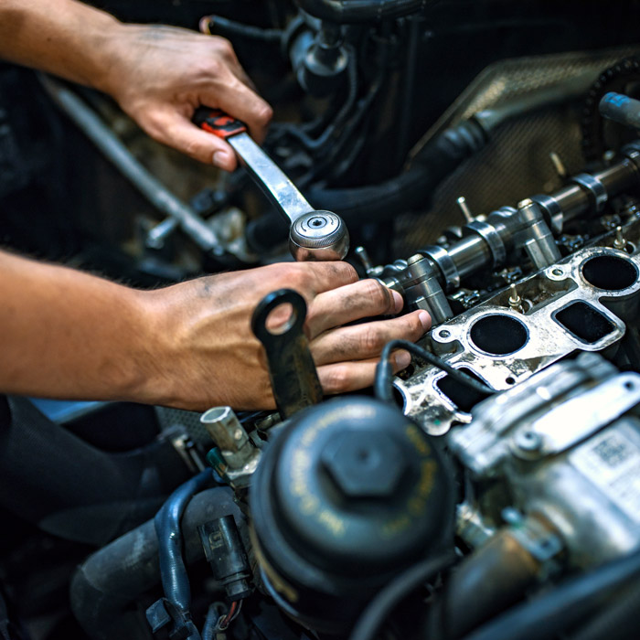 employee working under car hood