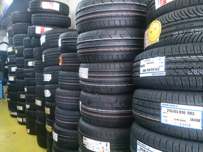 Stacks of new car tires in a shop