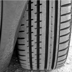 Close-up of a car tire with detailed tread pattern